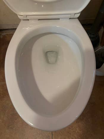 Toilet with lid open, showing clean bowl and water inside, suitable for modern bathroom shopping needs