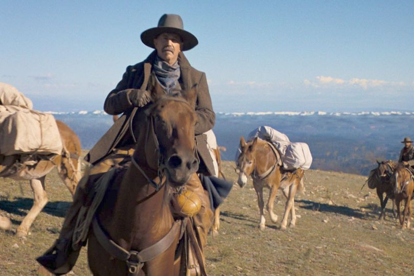 A man rides on a horse in the desert