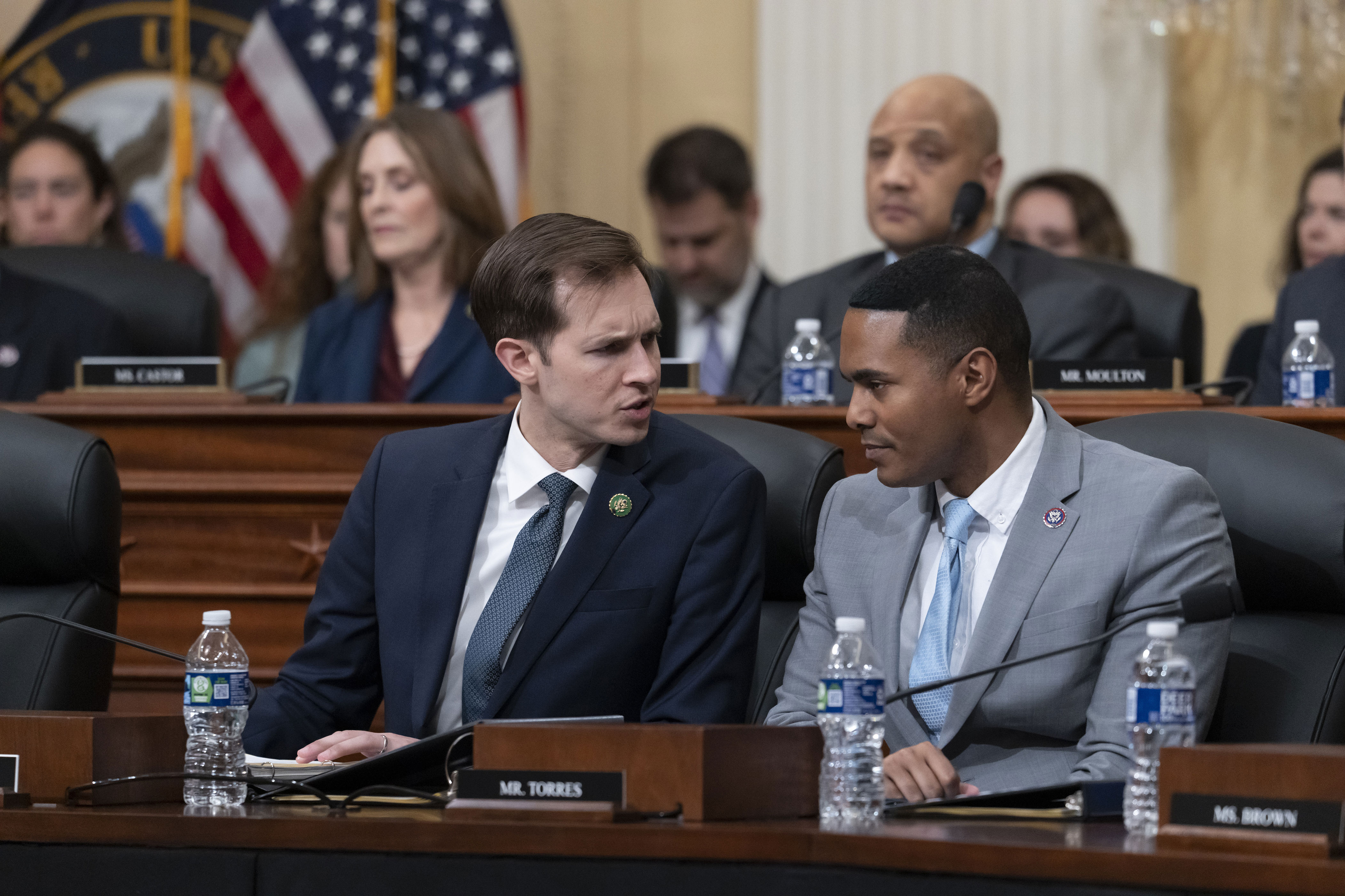 Rep. Jake Auchincloss (D-Massachusetts), left, and Rep. Ritchie Torres (D-New York) talk as a special House committee dedicated to countering China holds a hearing at the Capitol in Washington, Feb. 28, 2023.