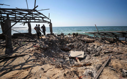 Palestinians inspect the site of an Israeli airstrike on Al-Baqa cafeteria - Mahmoud Issa
