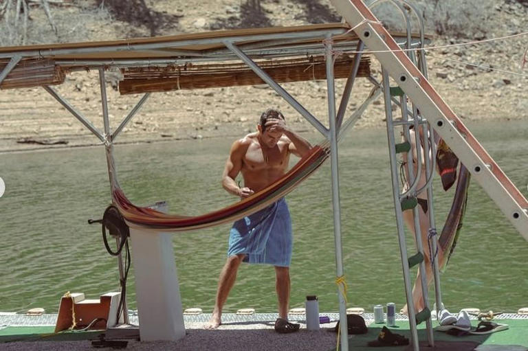 Shirtless Zac Efron shows off his chiseled torso as he enjoys lake
