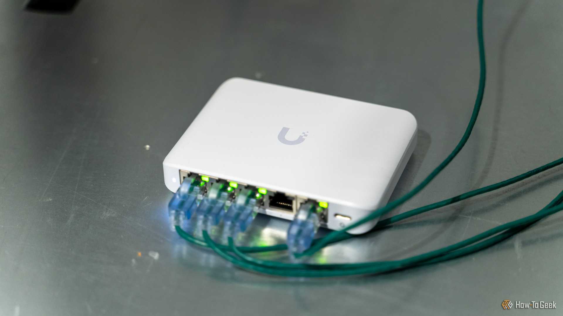 The Unifi Flex Mini 2.5G Ethernet switch with cables plugged in sitting on a server.