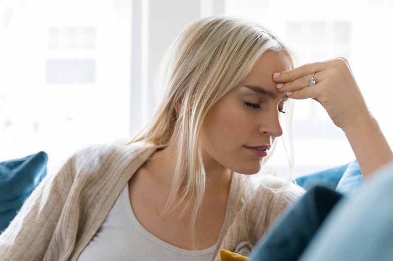 A headache is a common symptom of Covid (file image)