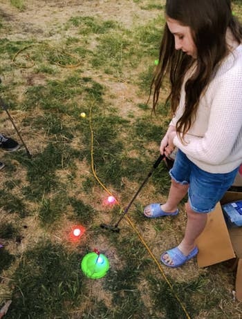 reviewer playing with golf set
