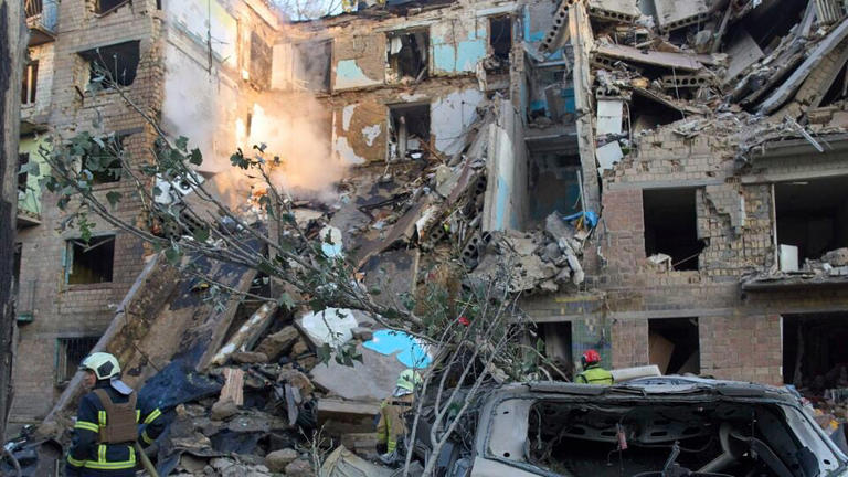 Firefighters work in a destroyed apartment building after a Russian attack in Kyiv, Ukraine, early Monday, June 23, 2025. (Image: AP/PTI)