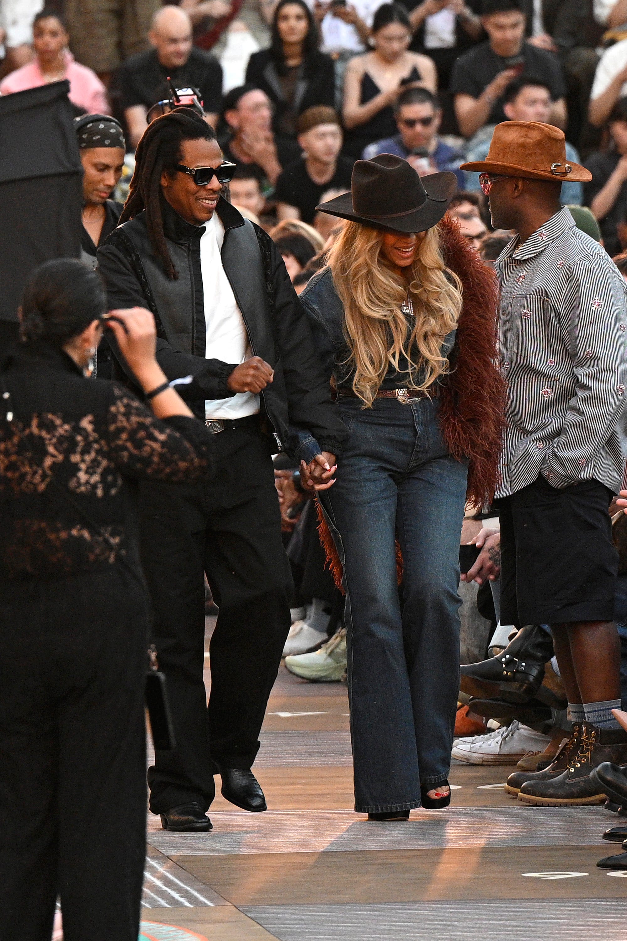 Beyoncé and Jay-Z making theri way to their seats at the Louis Vuitton fashion show on June 24, 2025.