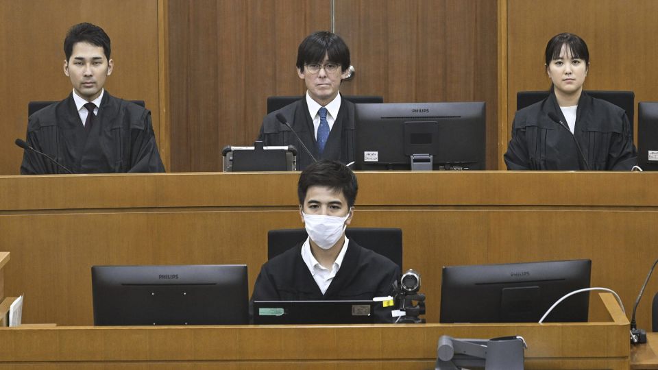 Judicial members, including Judge Kazuhiko Obata, center back, for the sexual assault case of U.S. Marine Lance Cpl. Jamel Clayton, at the Naha District Court in Okinawa.