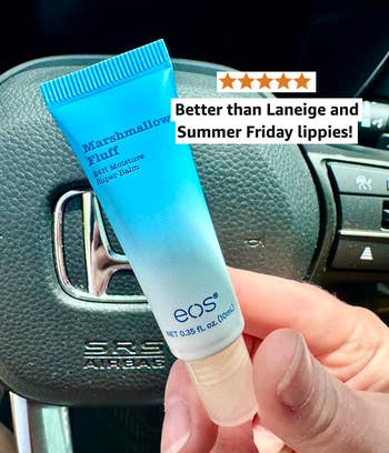 Hand holding a tube of Marshmallow Fluff lip balm with text praising it over other brands