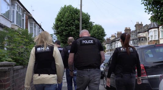 Officers taking part in the raids on Wednesday. (National Crime Agency/PA)