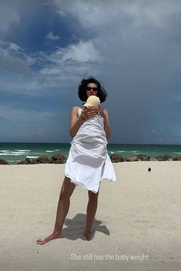 Elena Moussa wore a white dress with natural curls.