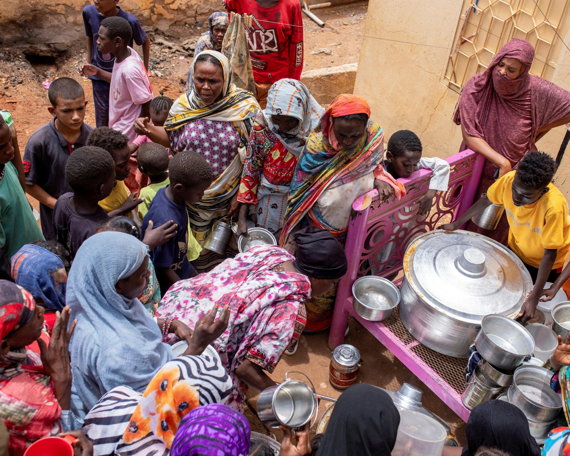 Meals are distributed for people who are out of reach of international aid efforts, in Omdurman, Sudan. Photograph: Mazin Alrasheed/Reuters