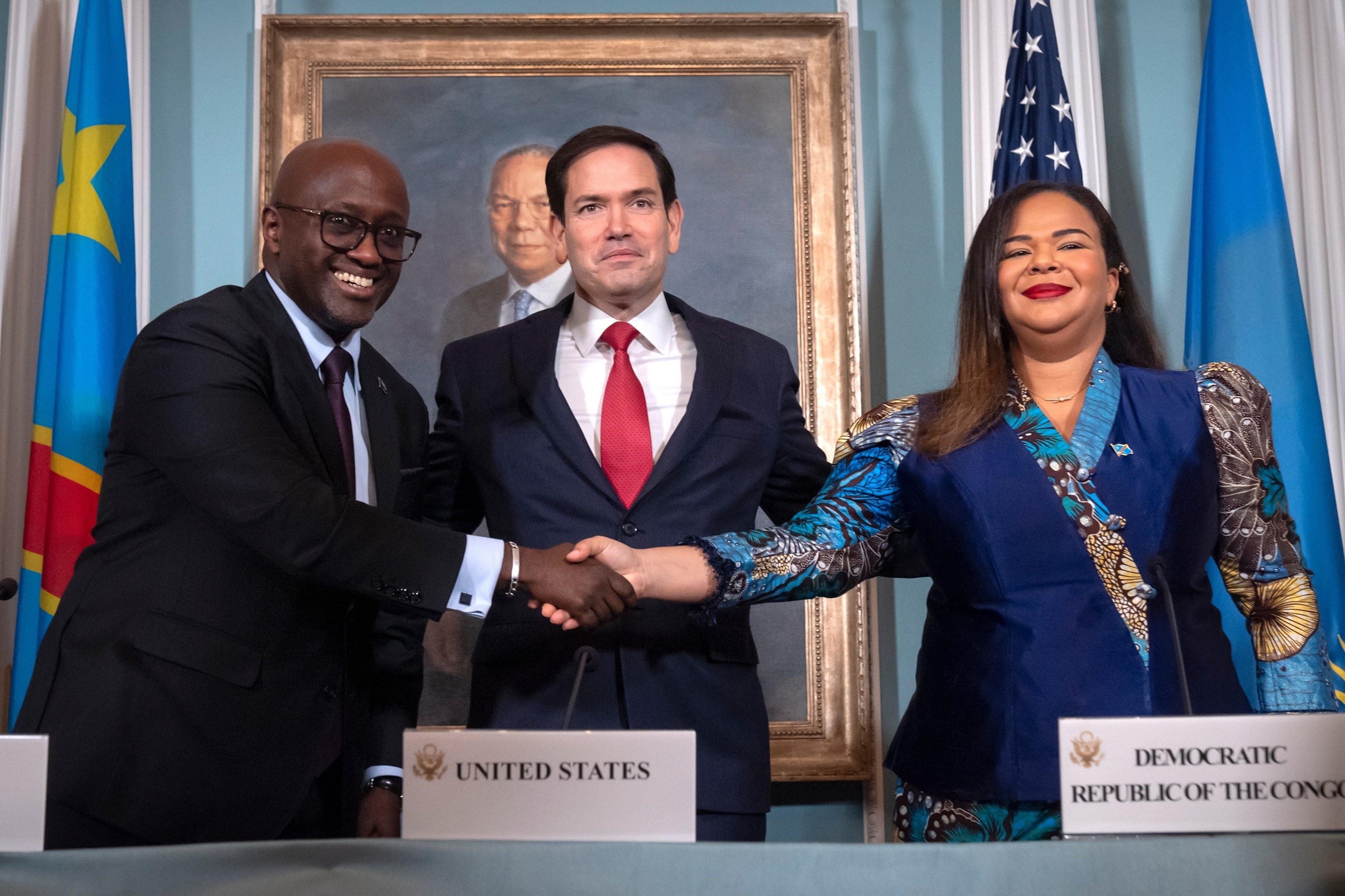 Mark Schiefelbein/AP - PHOTO: Secretary of State Marco Rubio stands with Rwanda's Foreign Minister Olivier Nduhungirehe and Congo's Foreign Minister Therese Kayikwamba Wagner as they shake hands after signing a peace agreement June 27, 2025, in Washington.