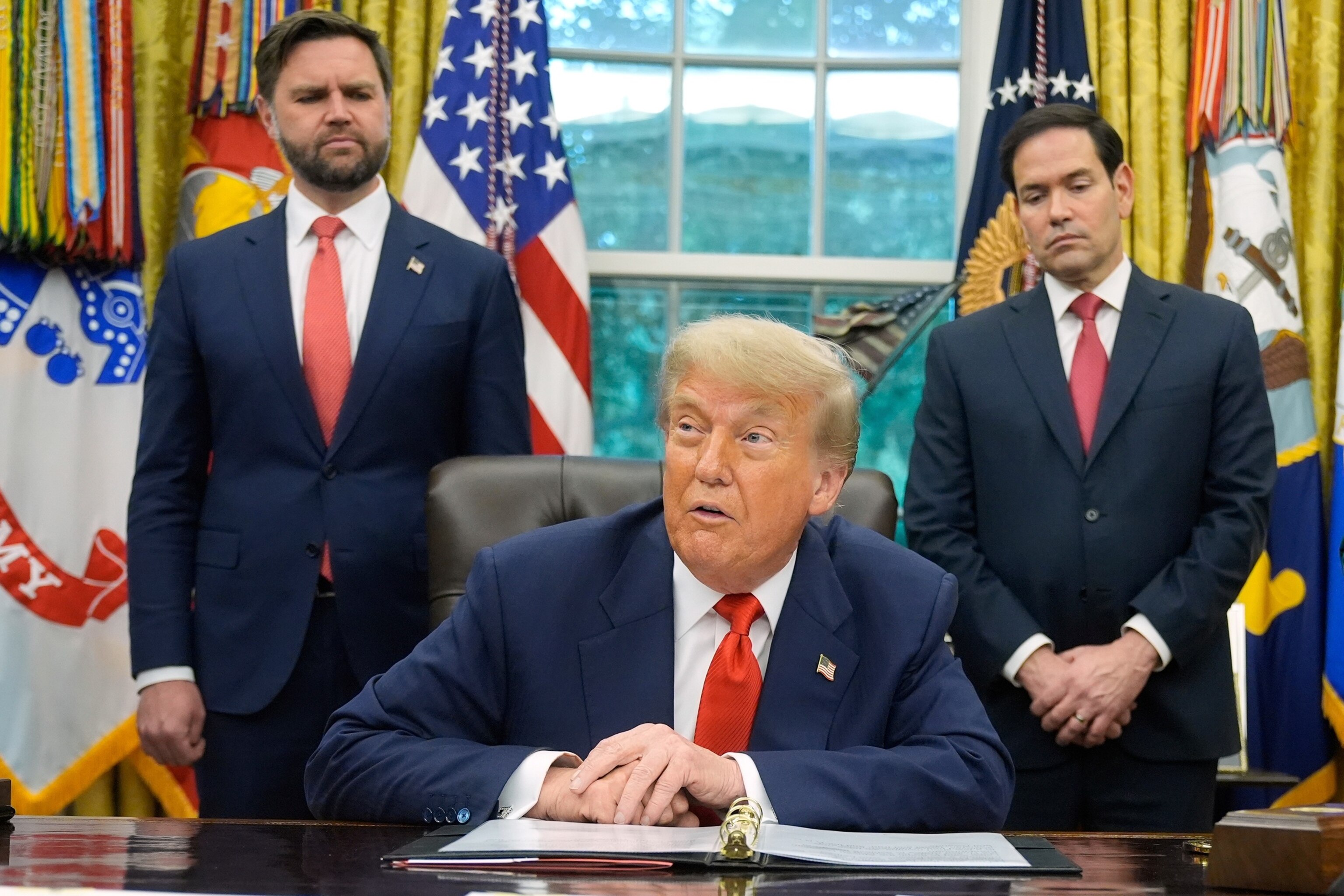 Manuel Balce Ceneta/AP - PHOTO: President Donald Trump speaks as Vice President JD Vance and Secretary of State Marco Rubio listen, June 27, 2025, in the Oval Office at the White House in Washington.