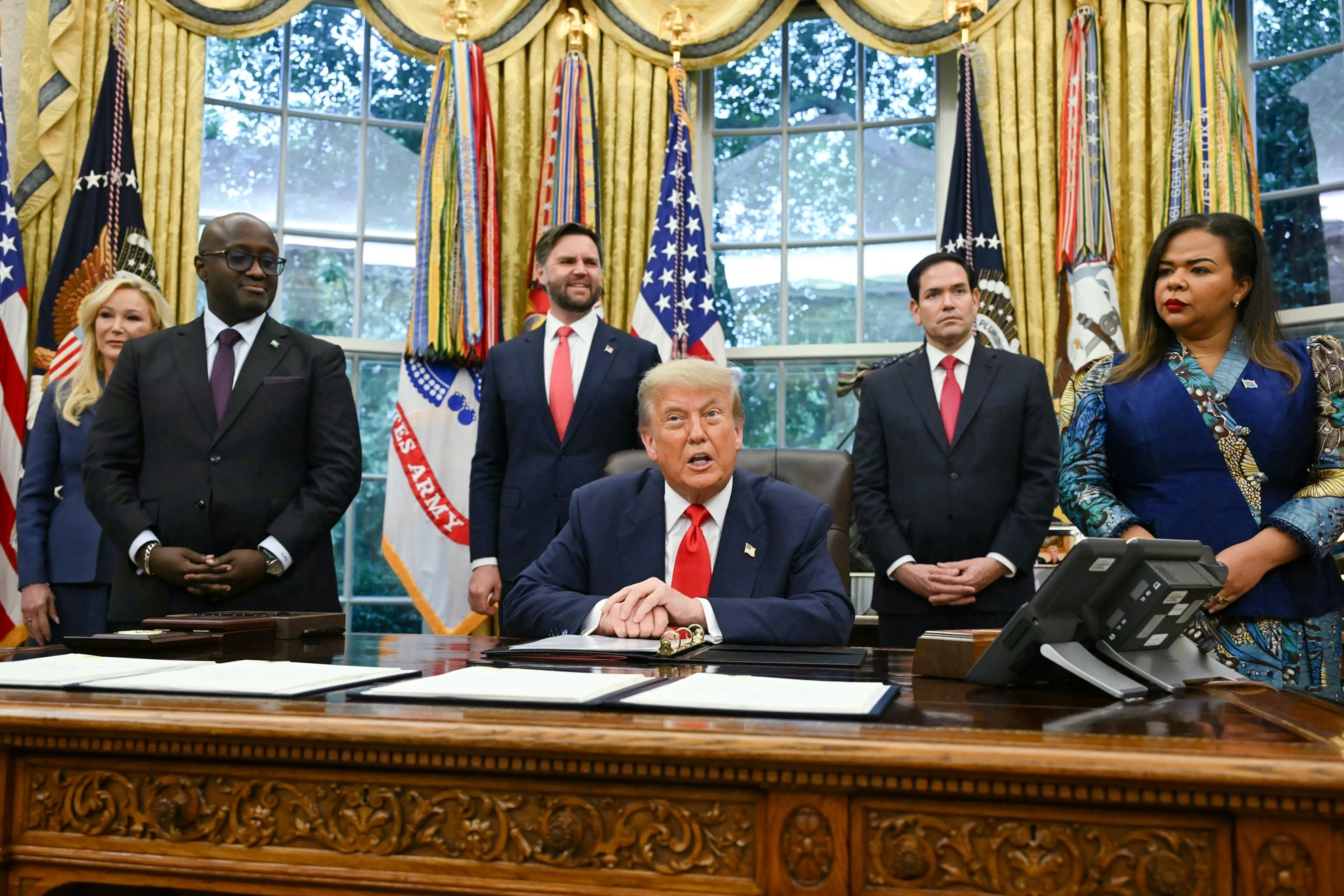 Andrew Caballero-Reynolds/AFP via Getty Images - PHOTO: President Donald Trump meets Democratic Republic of the Congo's Foreign Minister Therese Kayikwamba Wagner and Rwanda's Foreign Minister Olivier Nduhungirehe in the Oval Office at the White House in Washington, June 27, 2025.