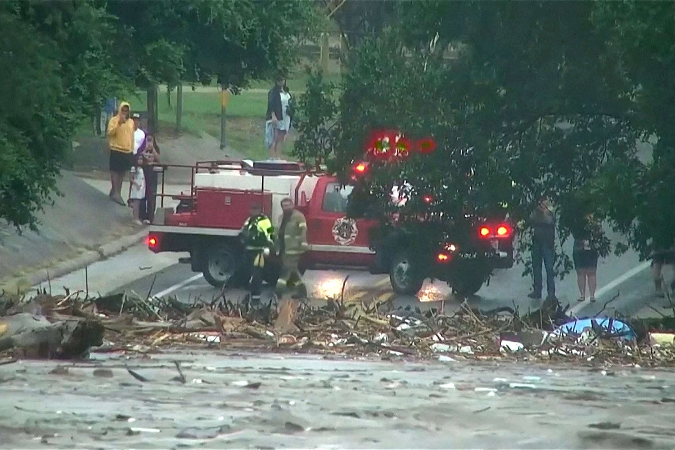 Flooding along the Guadalupe River in Texas has killed 18 adults and nine children. About 25 young girls from Camp Mystic, a Christian summer camp that sits near the river, are still missing. / ABC Affiliate KSAT via Reuters