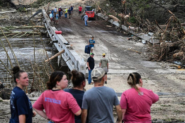 Rescuers attempt to locate those swept away in the flood
