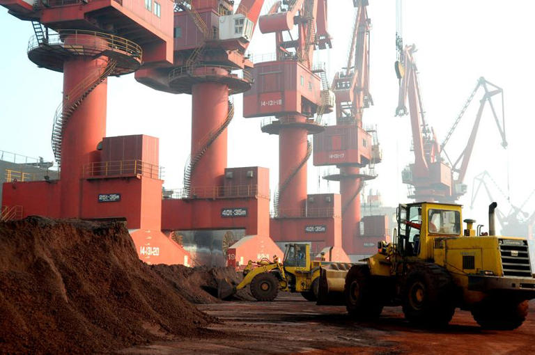 FILE PHOTO: Workers transport soil containing rare earth elements for export at a port in Lianyungang, Jiangsu province, China October 31, 2010. Picture taken October 31, 2010. REUTERS/Stringer/File Photo