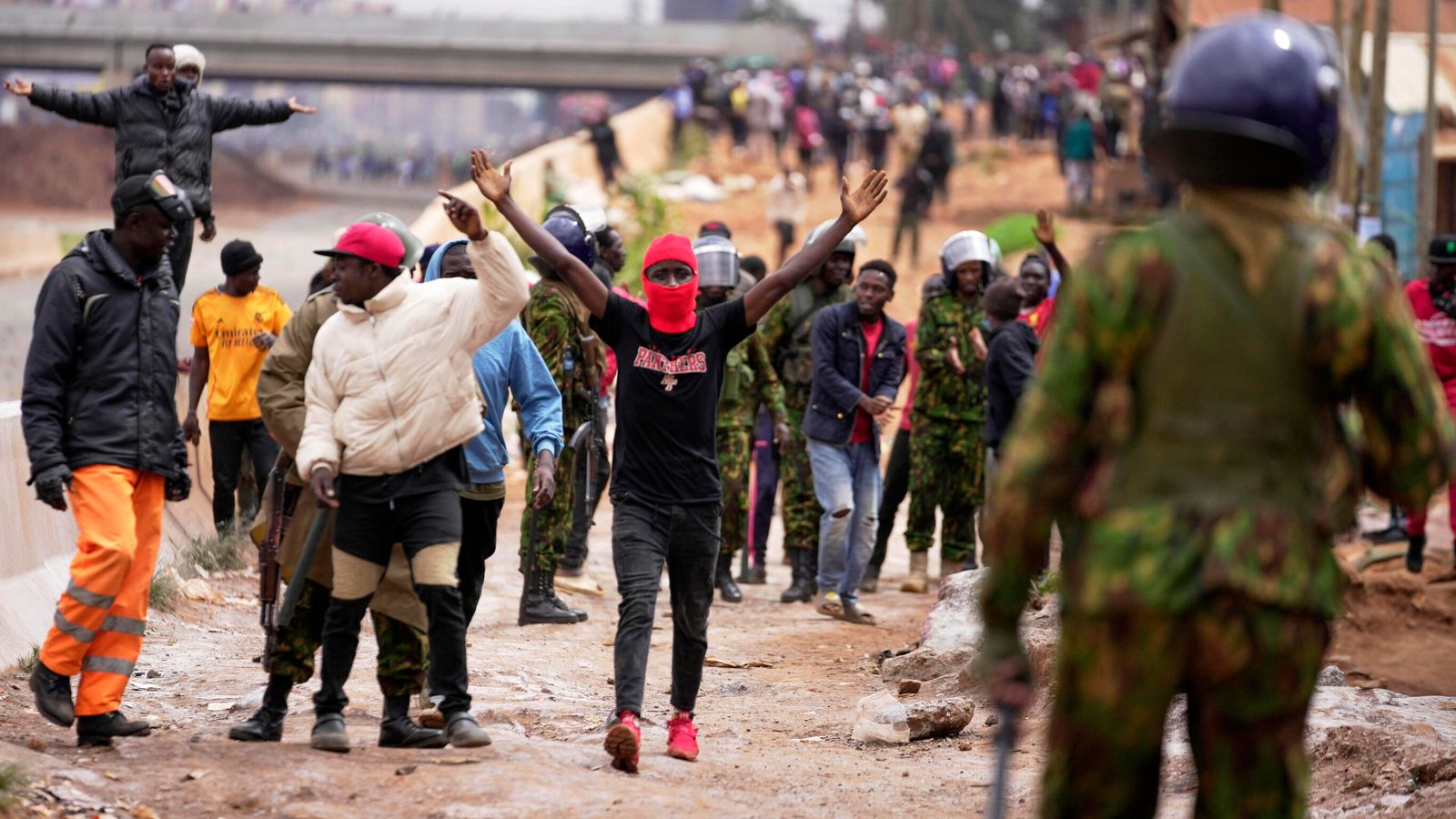 Demonstrators gesture to anti-riot police. Pic: AP
