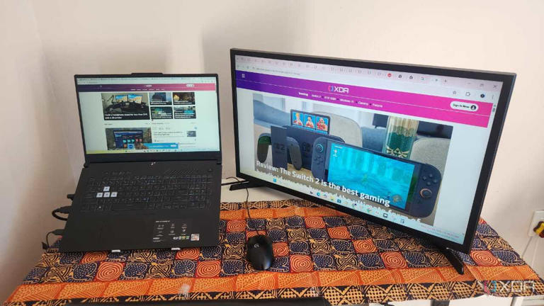 laptop and TV on a desk