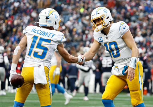 FOXBOROUGH, MASSACHUSETTS - DECEMBER 28: Ladd McConkey #15 of the Los Angeles Chargers celebrates with Justin Herbert #10 after scoring a touchdown during the second quarter against the New England Patriots at Gillette Stadium on December 28, 2024 in Foxborough, Massachusetts. (Photo by Winslow Townson/Getty Images)
