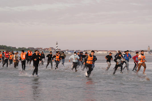 People thought to be migrants run across the beach in Gravelines, France, in a bid to board a small boat (PA Wire)