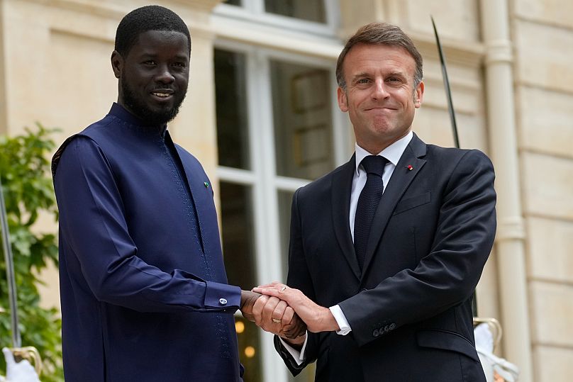 French President Emmanuel Macron welcomes Senegal's President Bassirou Diomaye Faye before a working lunch in Paris, 20 June, 2024 AP Photo