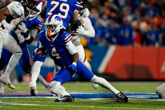 Buffalo Bills' James Cook runs with the ball against the Denver Broncos.