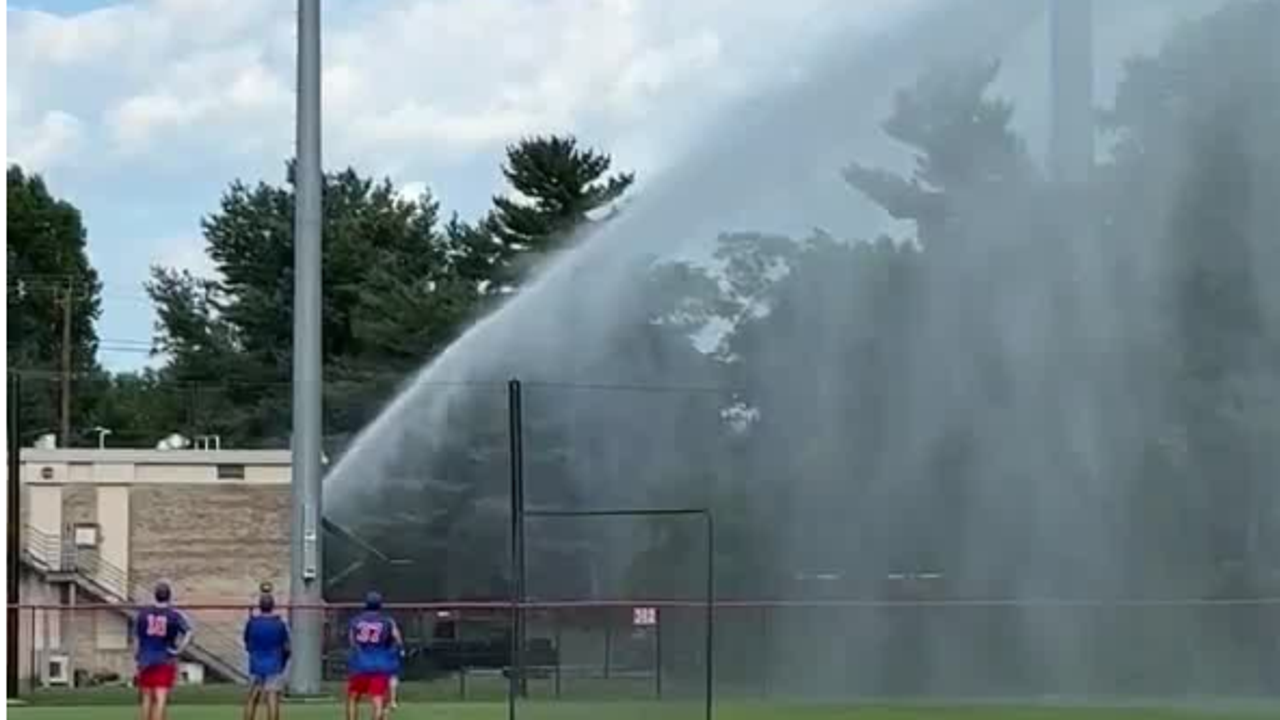 Firefighter ends baseball game with fire hose after ball hits his car ...