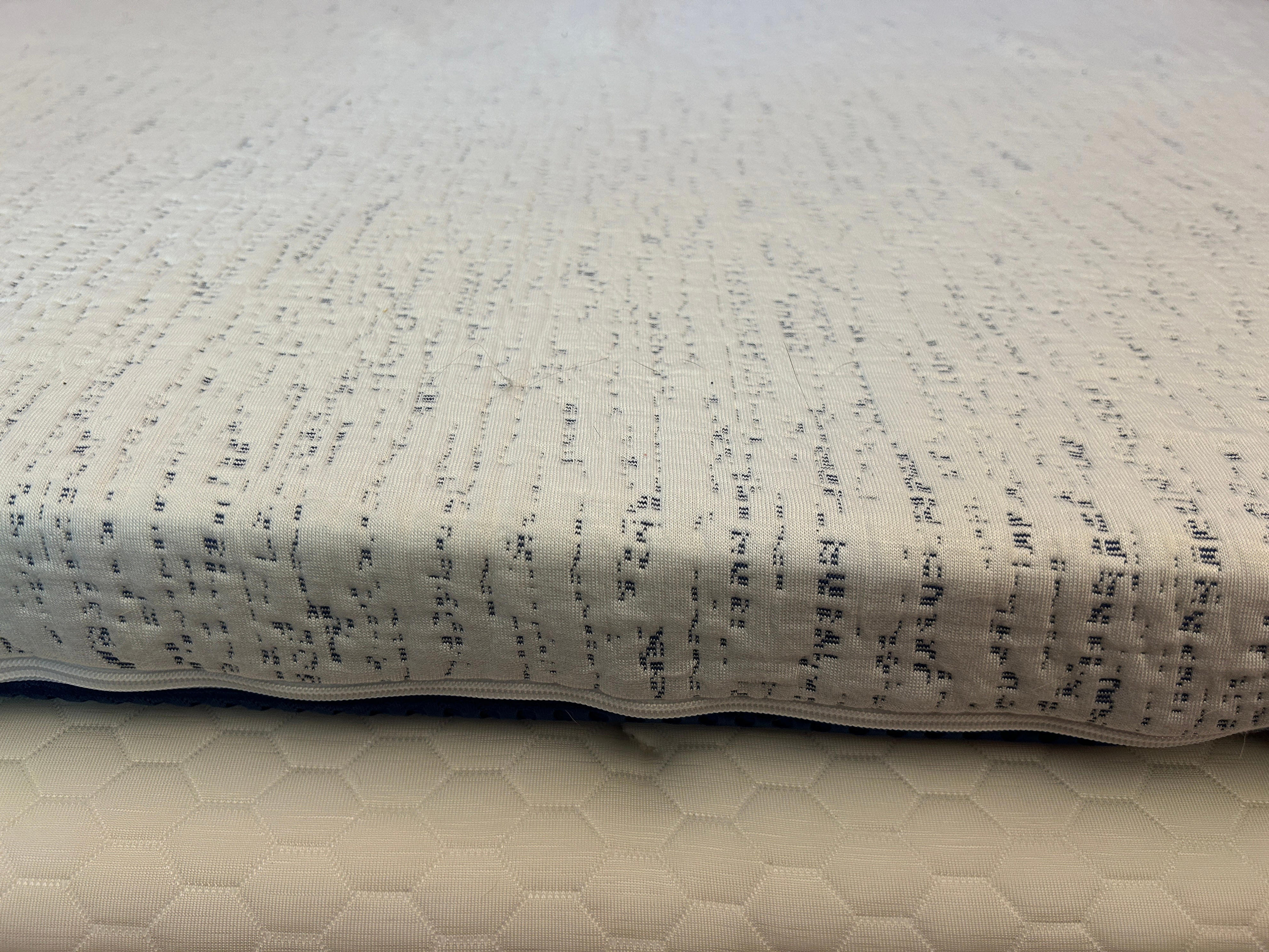 An up-close image of the Viscosoft Mattress topper on a mattress, featuring a zipper with cover.