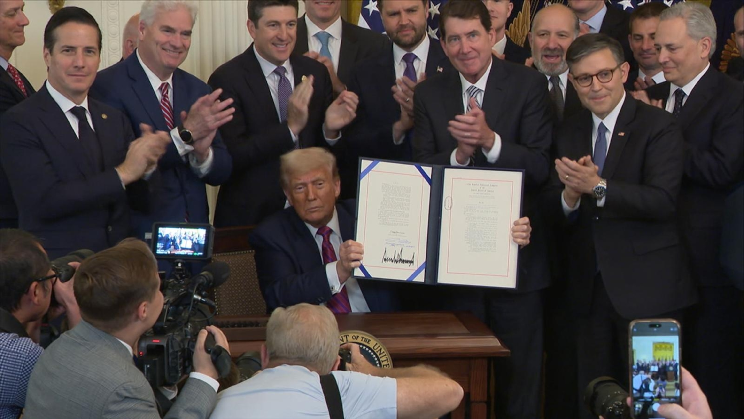 Trump signs 1st major federal cryptocurrency bill into law | Watch