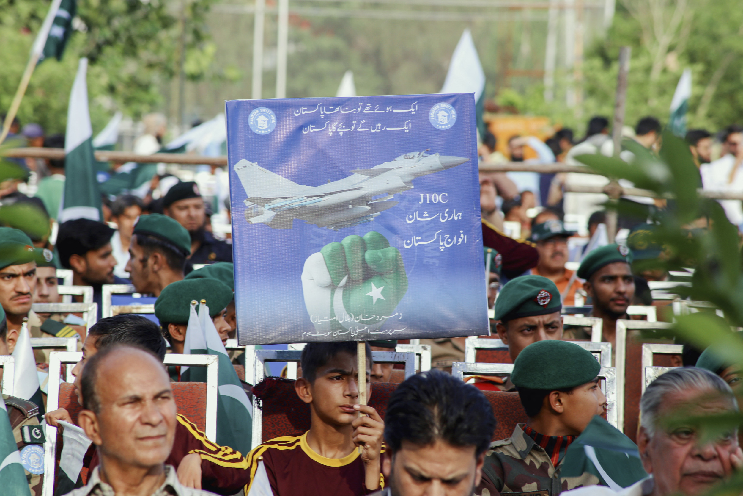 A young boy holds a placard of Chinese fighter jet J-10C as Pakistani people participate in a public gathering of gratitude organized by Parks and Horticulture Authorities (PHA) held at Liaquat Bagh in Rawalpindi, Pakistan on Monday, May 12, 2025. Zubair Abbasi/Middle East Images/AFP/Getty Images