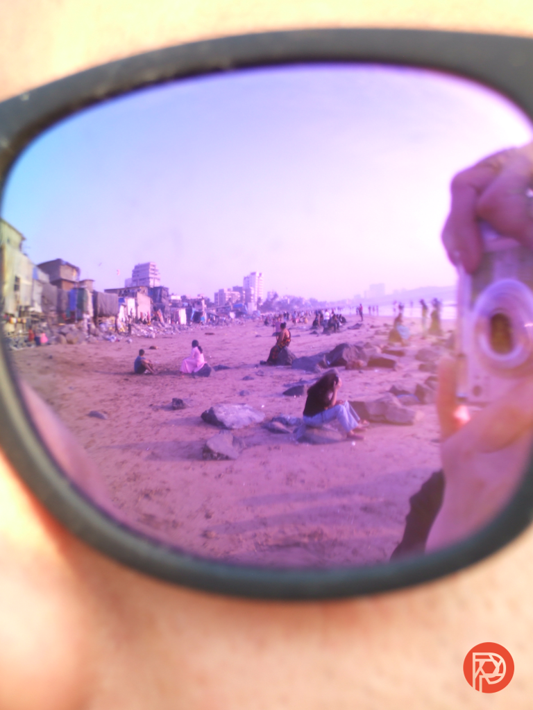 A close-up of the reflection of people in sunglasses
