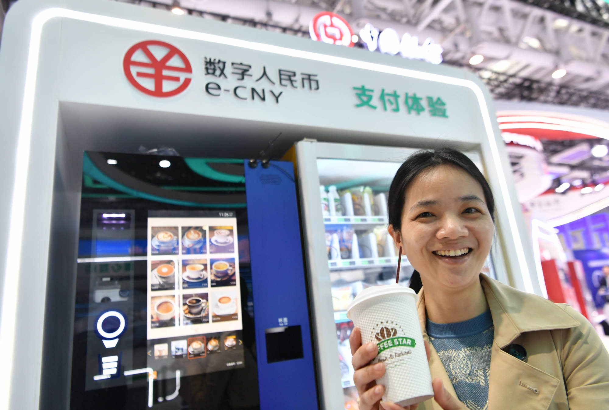 A visitor displays a cup of coffee bought using e-CNY at the 6th Digital China Summit in Fuzhou, Fujian province, China, on April 26, 2023. Photo: Xinhua