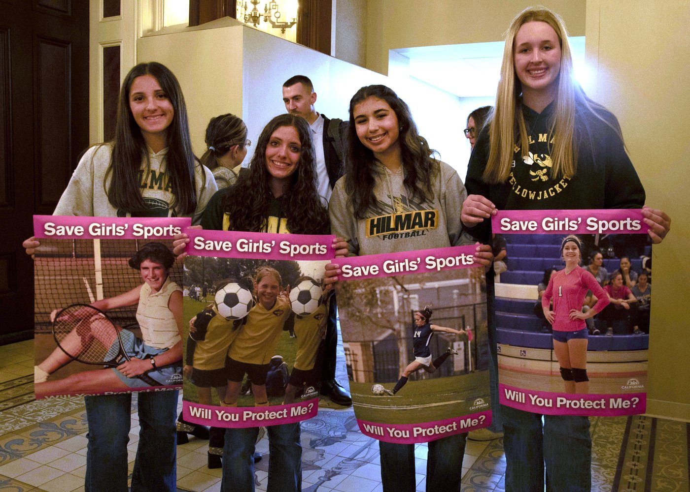 FILE - Student athletes hold signs during a hearing to consider bills to pass rules banning transgender student-athletes, April 1, 2025, in Sacramento, Calif. (AP Photo/Yuri Avila, File)