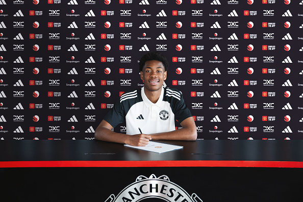 Kana-Biyik signing his contract at Old Trafford (Picture: Getty Images)