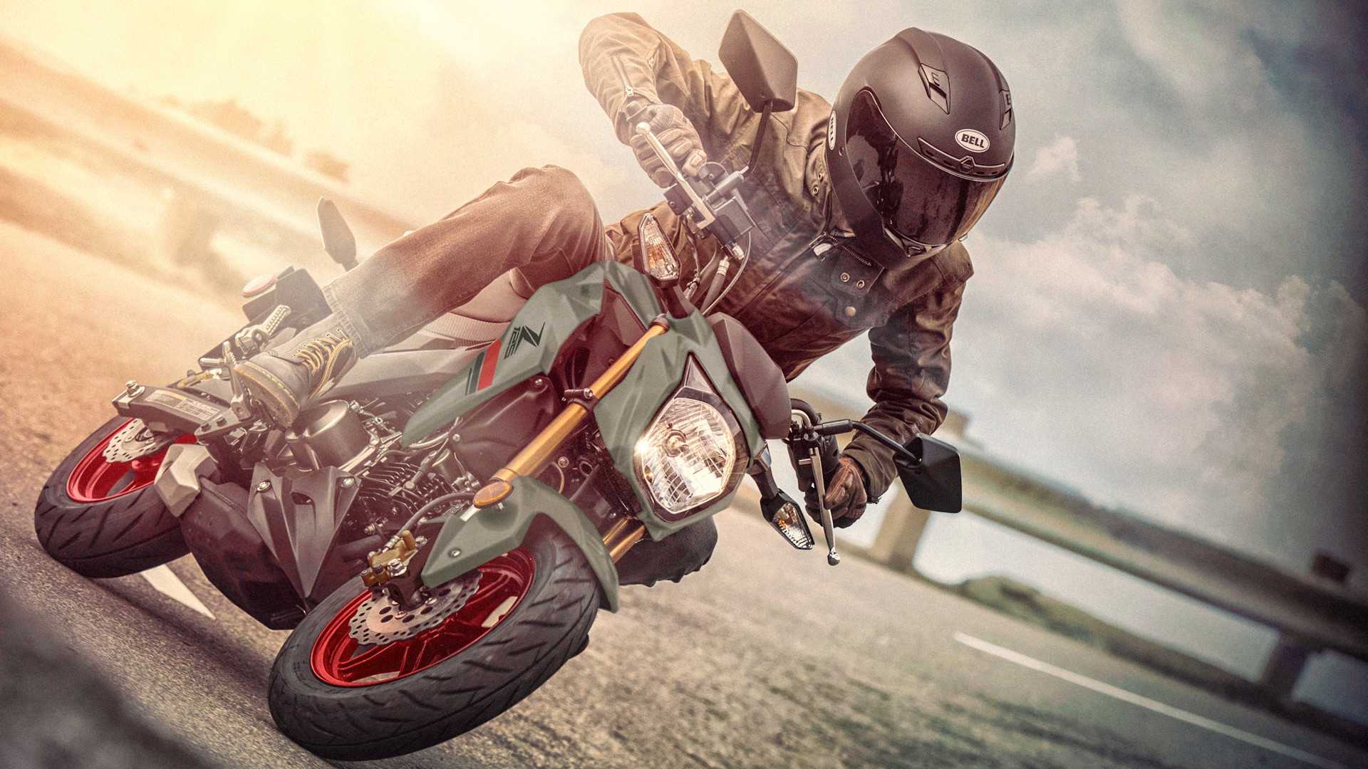 Green 2023 Kawasaki Z125 PRO coming out of a curve