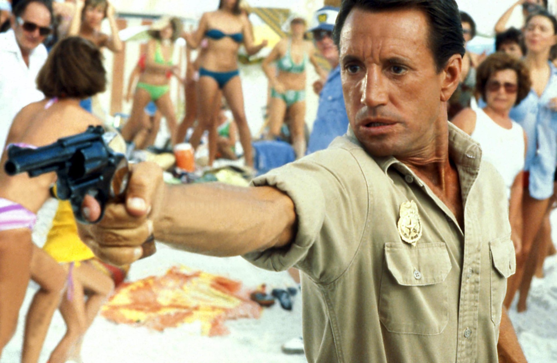 Roy Scheider as Sheriff Martin Brody pointing a gun in Jaws 2