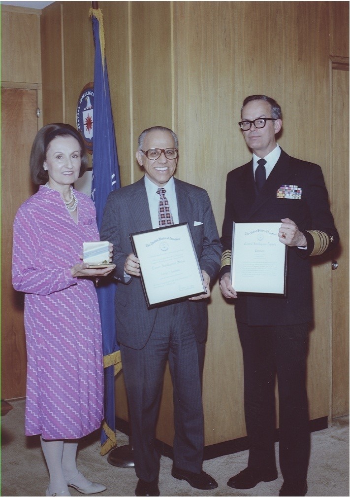George Joannides, center, receives a “Career Intelligence Medal” from the CIA for his activities with the agency, with the agency specifically citing his work with anti-Castro students in Miami and with the House committee that investigated the JFK assassination. Staffers said he obstructed their work.
