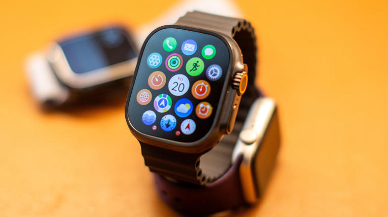 Close up of Apple Watch and apps with two Apple Watches in the background