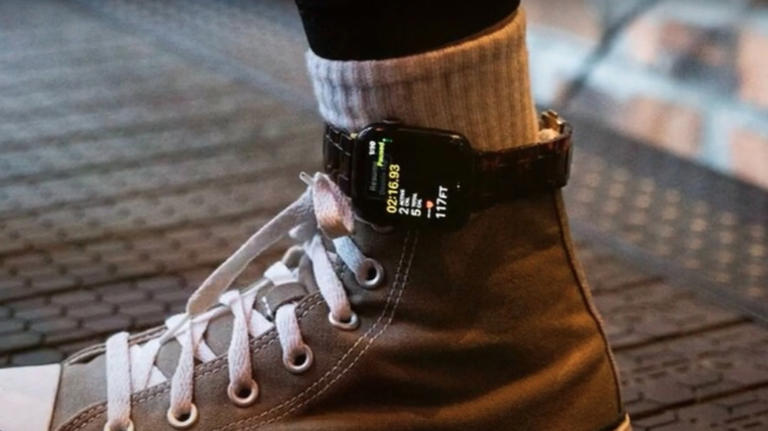 Person wearing converse hightops with Apple Watch strapped to ankle