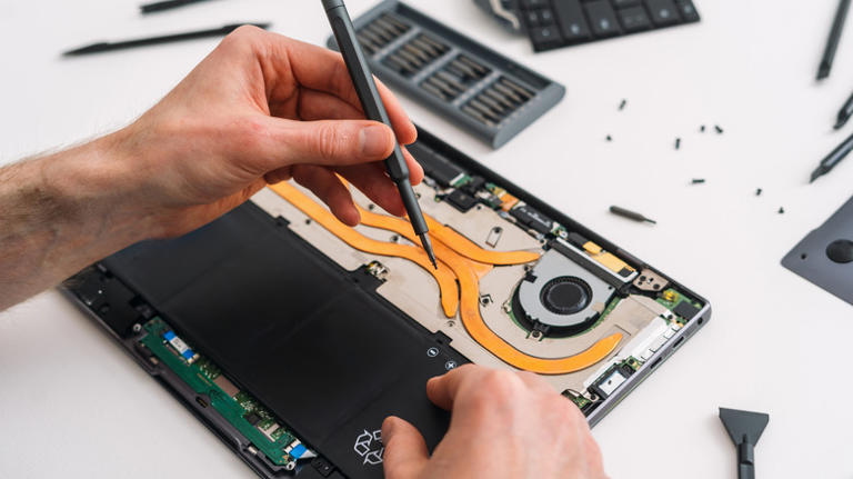 Man replacing an internal laptop battery