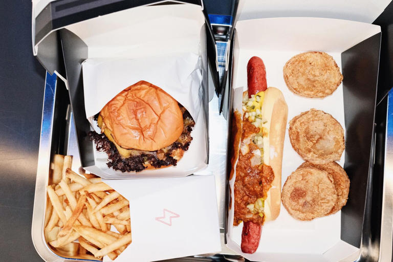 A Tesla smashburger, tallow fries, wagyu-chili hot dog and hash brown bites prepared in the all-electric kitchen of the Tesla Diner. ((Stephanie Breijo / Los Angeles Times))