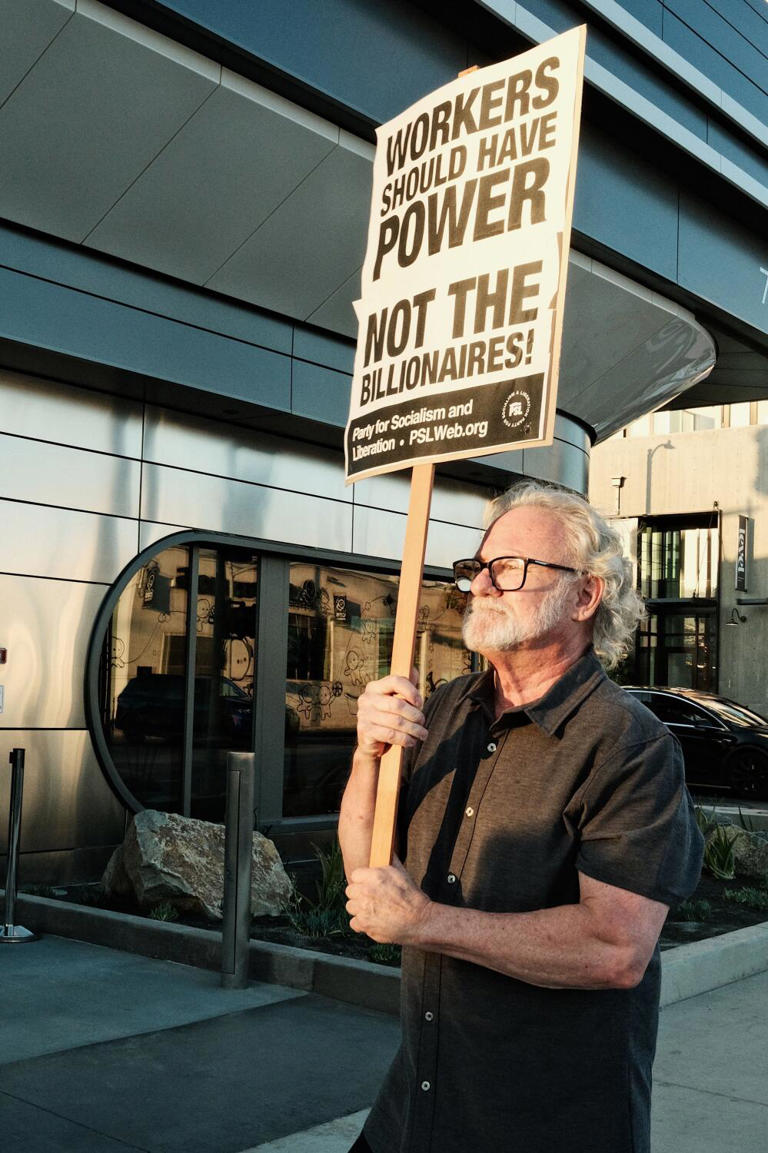 Neighborhood resident Charles Happold protests the Tesla Diner on its opening day. ((Stephanie Breijo / Los Angeles Times))
