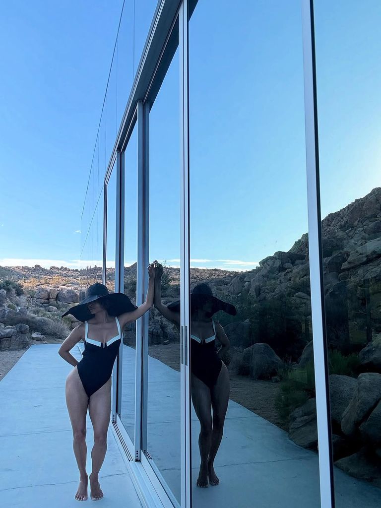 Halle Berry in black and white swimsuit in desert
