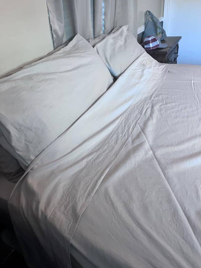 reviewer's bed with white sheets
