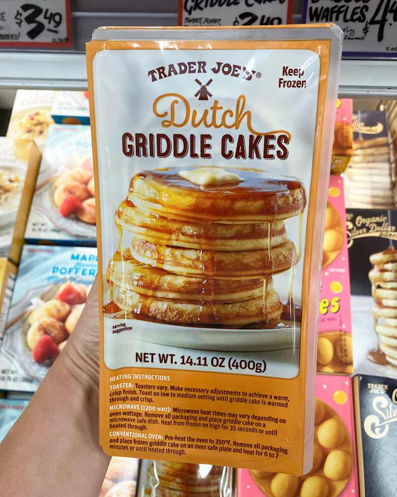 someone holding a package of Trader Joe's Dutch Griddle Cakes in the store