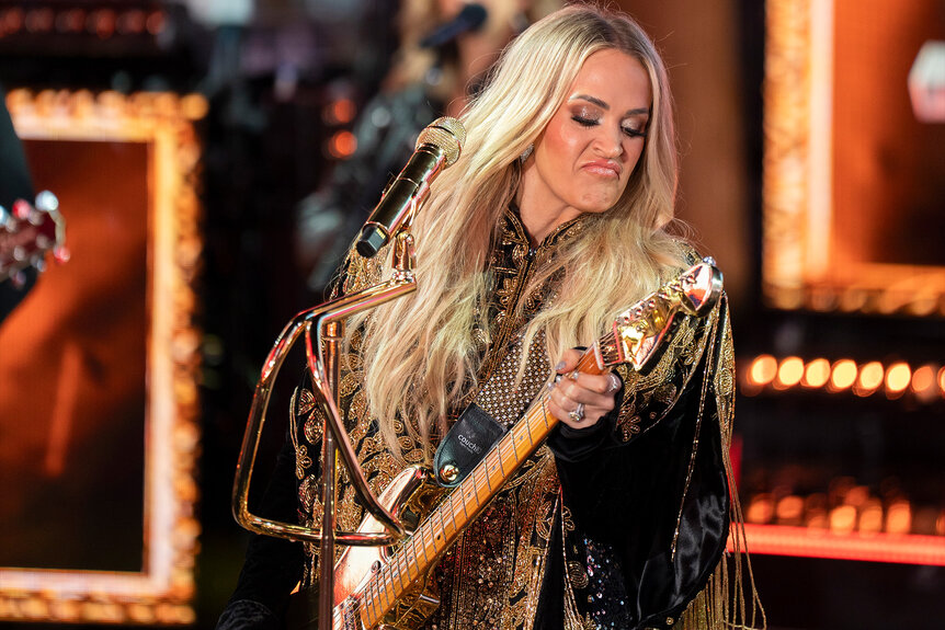 Carrie Underwood plays the guitar onstage.