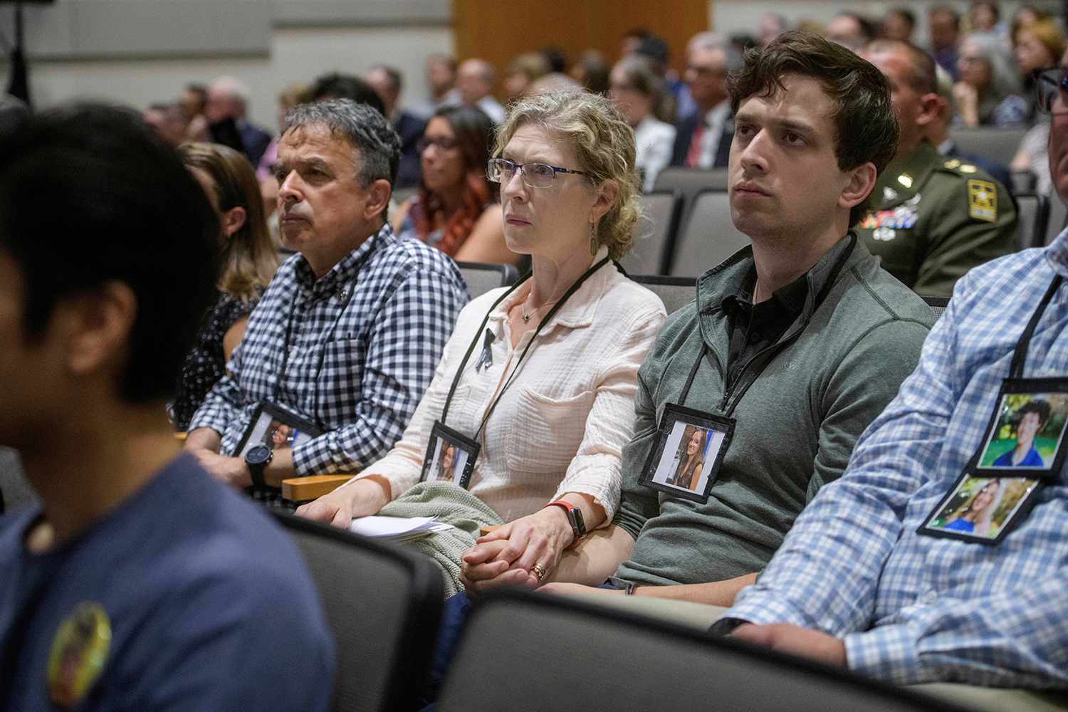 Loved Ones Wear Photos of D.C. Plane Crash Victims While Attending