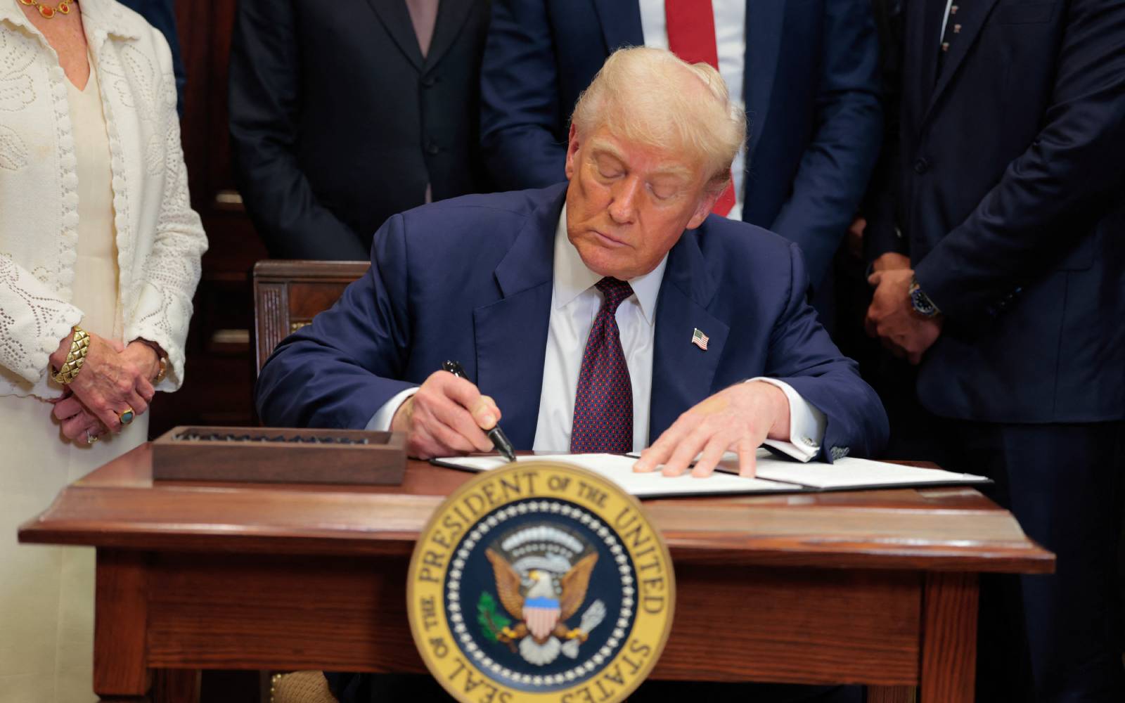 Trump signs order to impose higher tariffs on dozens of economies