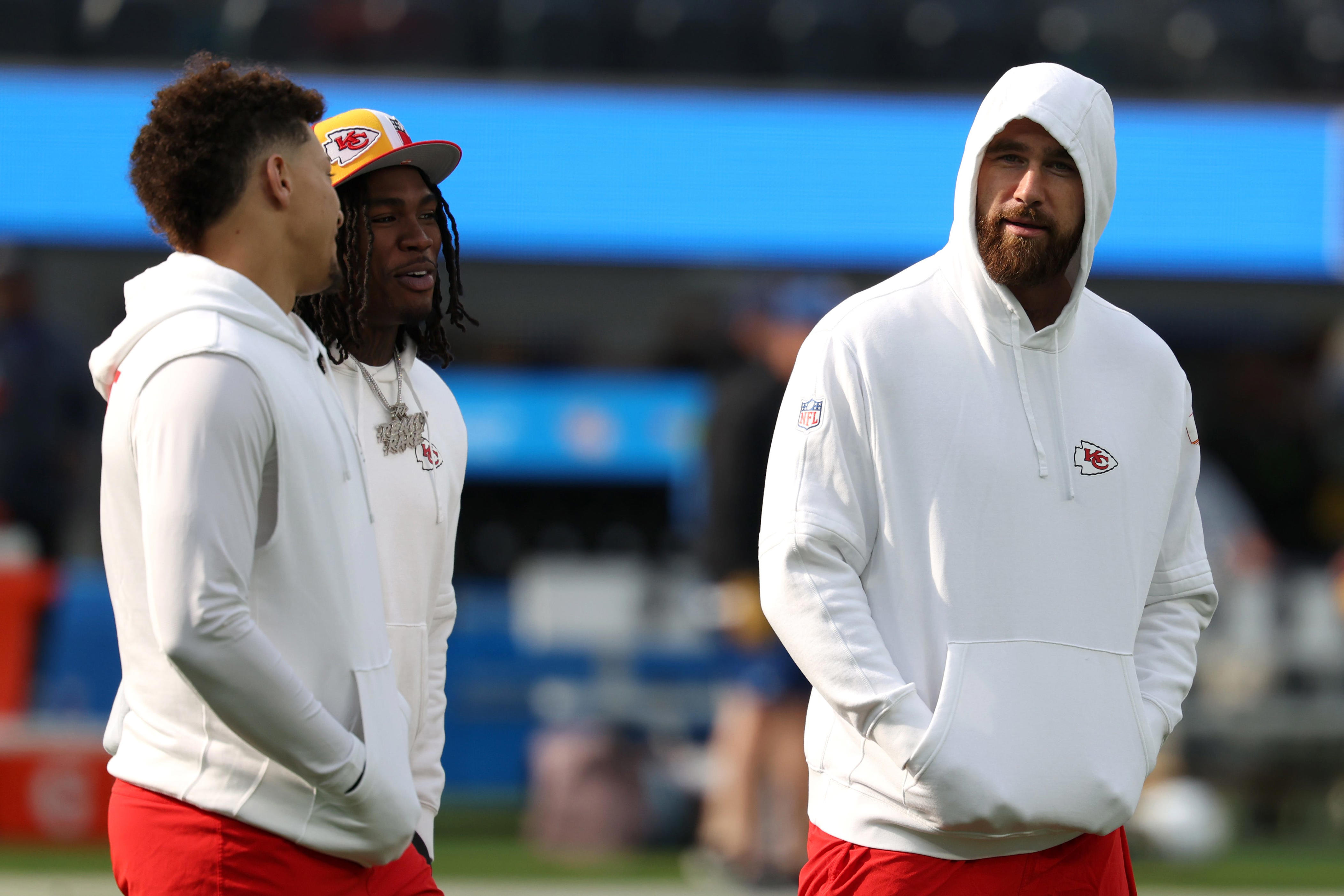 Jan 7, 2024; Inglewood, California, USA; Kansas City Chiefs quarterback Patrick Mahomes (15) talks to wide receiver Rashee Rice (4) and tight end Travis Kelce (87) before the game against the Los Angeles Chargers at SoFi Stadium. Mandatory Credit: Kiyoshi Mio-USA TODAY Sports